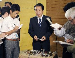 PM Kan speaks to reporters