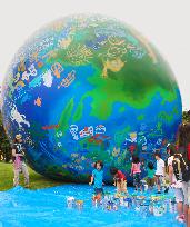 Kids paint on world's largest globe