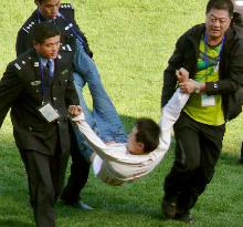 Intruder disrupts Japan soccer match in China