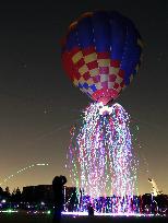 Paper strips with LED lights released from hot air balloon