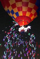 Paper strips with LED lights released from hot air balloon