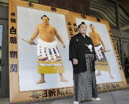 Yokozuna Hakuho with winner's portraits