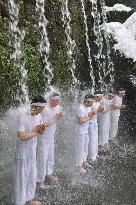 Ablutions under waterfall