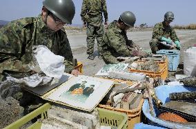 SDF members clean photo albums retrieved