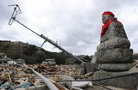 Buddhist deity statue in rubble