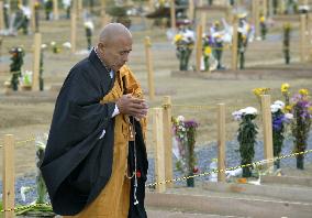 Monk at cemetery for tsunami victims