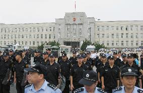 Police stand guard city building in Dalian