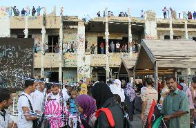 Tourists visit Gaddafi's former residence