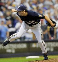 Brewers' Saito earns 1st playoff win