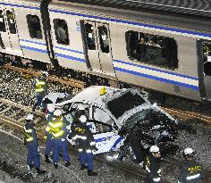 Taxi falls onto railway track in Tokyo