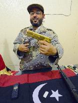 Gaddafi's pistol, satellite phone
