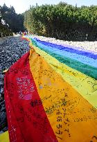 100-meter-long rainbow flag on 8th-month tsunami anniv.