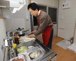 Iwate Gov. Tasso experiences life in temporary housing