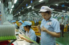 Workers at Mabuchi Motor plant in Vietnam