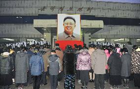 Citizens mourn before Kim's portrait