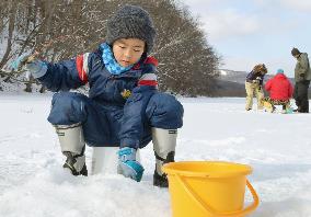 Smelt fishing on frozen lake in Hokkaido