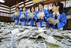 Bankers count money offered at Osaka shrine