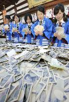 Bankers count money offered at Osaka shrine