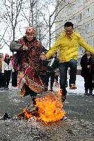 Jumping over burning straw effigy