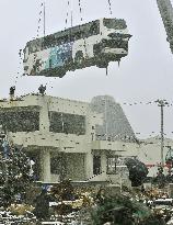 Bus removed from roof of building