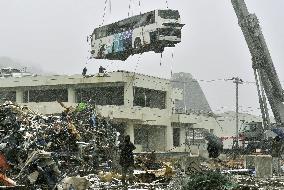 Bus removed from roof of building