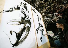 Painting under cherry blossoms