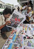 People read paper in Myanmar