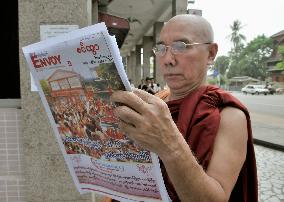 Monk reads paper in Myanmar