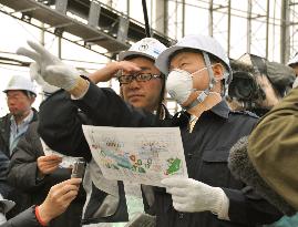 Toyama gov. inspects temporary site for disaster debris