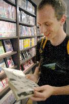 Visitor from Switzerland takes a look at "manga" book