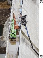 Crane topples at dam construction site