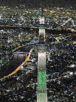 Tokyo Skytree lit up in pine tree color