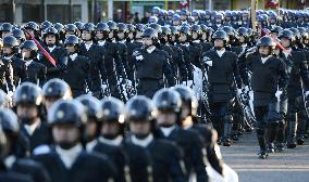 Riot police officers marching