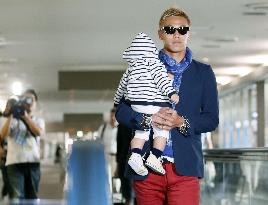 Honda arrives in Japan with baby son
