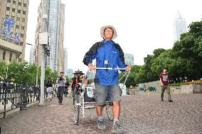 Japanese man completes walk around world with 2-wheeled cart