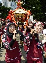 Indonesian girls carry Japanese portable shrine