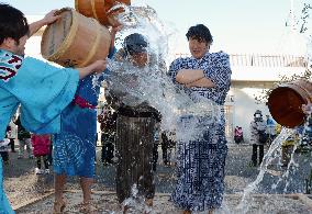 Bridegrooms splashed with cold water for fire prevention