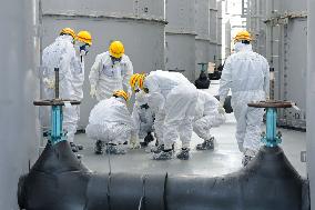 Local officials inspect contaminated-water tanks at Fukushima plant