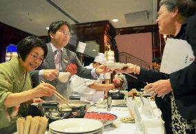 Japan farm minister serves meal at reception in Berlin