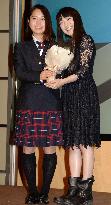 Ski jumper Takanashi receives flowers from singer miwa