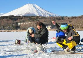 Fishers gather near Mt. Fuji to fish for lake smelt