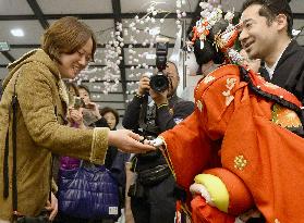 Woman shaking hands with Bunraku puppet