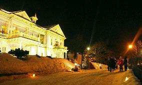 Candles illuminate snowy path in Hakodate