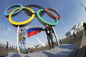 Holding Russian flag under Olympic rings