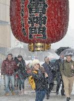 Tourists visit Senso-ji temple in Asakusa under heavy snow