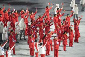 Chinese team members wave flags during Sochi Olympics opening ceremony