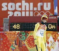 Japanese ski jumper Kasai looks at scoreboard in Sochi