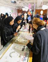 Saudi women look at accessories at Japan fair in Riyadh