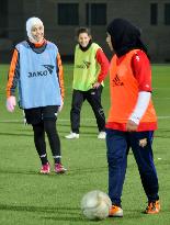 Jordanian women's soccer players wear headscarves