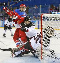 Japan players defend goal against Russia in women's ice hockey
